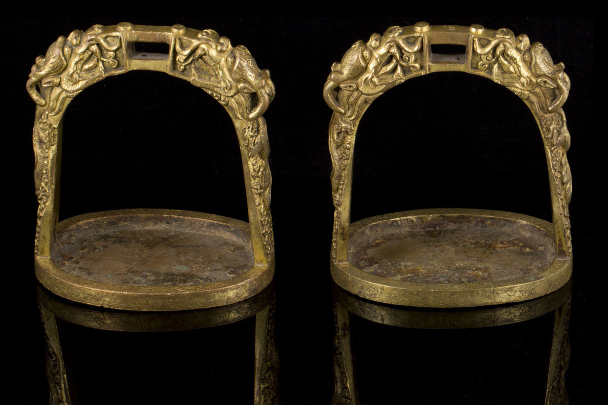 A rare pair of early Qing five clawed dragons gilt bronze stirrups